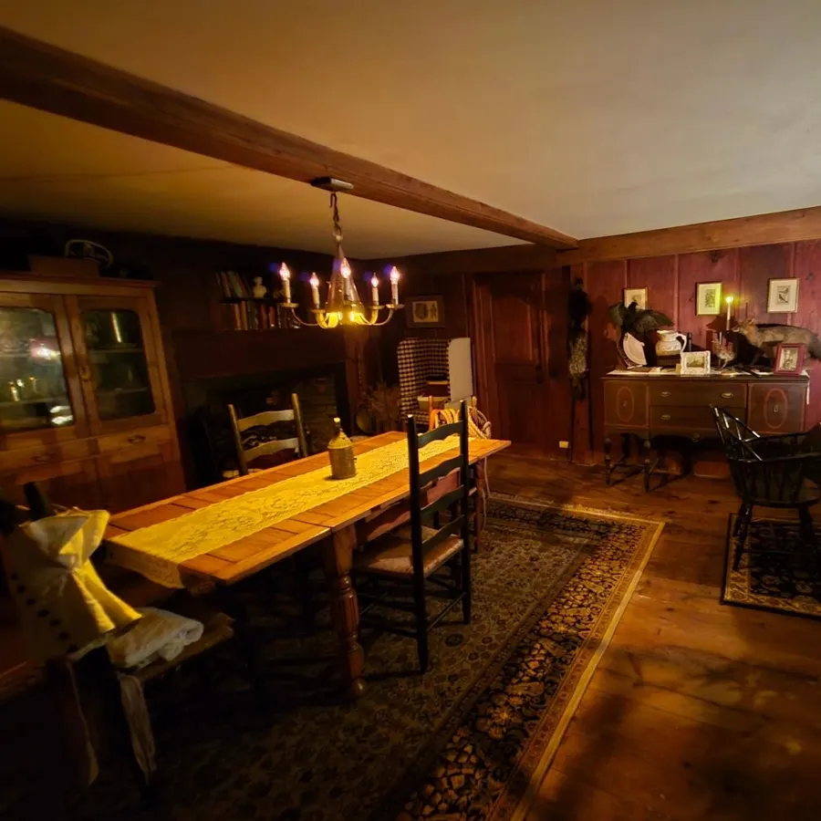 Dining room with a long table and chandelier