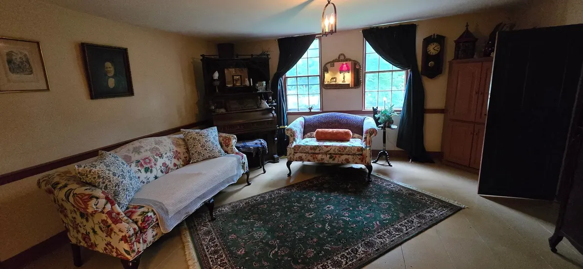 Main parlor with a built-in corner cabinet